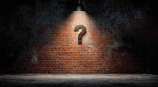 A lone question mark illuminated on a gritty brick wall by a spotlight