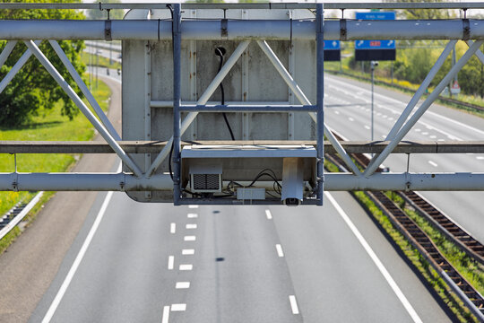 Utrecht, Netherlands. Speed camera and automatic number plate recognition system mounted on a gantry over the A2 highway to monitor traffic speed and safety.