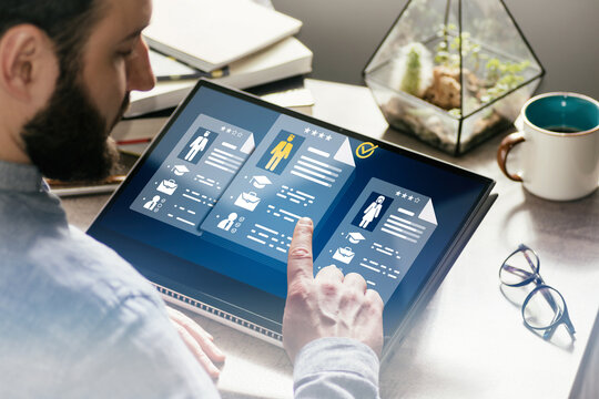 Person using a tablet to review digital resumes and select candidates, representing online recruitment, HR screening and hiring process.