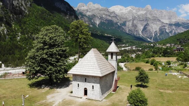 Theth village church. Summer landscape of Theth Mountains in Albanian Alps (also known as Accursed Mountains). Alps of Albania National Park.