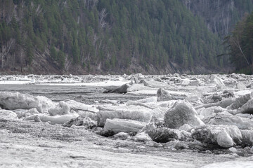 Spring ice drift on northern river with huge drifting ice blocks and melting river ice, natural landscape with cold water and forest, concept of global warming, climate change and seasonal thaw © Vladimir Razgulyaev
