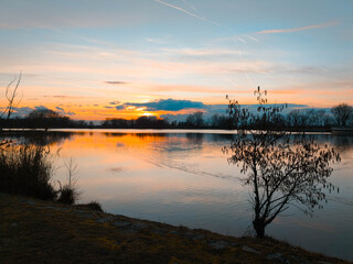 Fototapeta premium Summer sunset or sundowner view with reflections near Plattling, Isar, Deggendorf, Bavaria, Germany