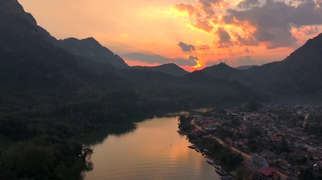 Beautiful Sunset in Nong Khiaw, a drone shot of picturesque Mountain Town on the Nam Ou River in Laos, Southeast Asia