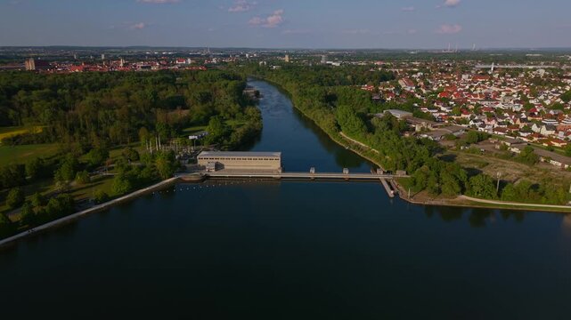 Aerial panorama of the Danube at Ingolstadt shows the reservoir, dam structure and Vogelinsel. Sunny weather and Bavarian nature create a wide scenic view of the hydropower landscape.