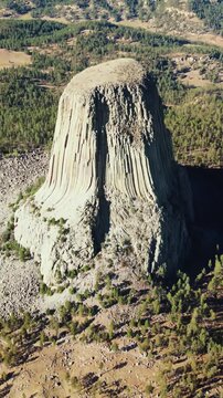 Aerial cinematic view of iconic devil tower national monument landscape in wyoming united states desert.