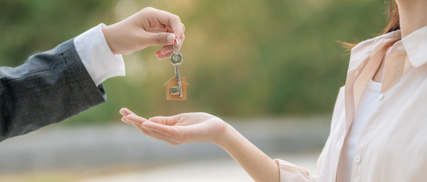 lease, rental and selling home. Real estate agent manager smile holding key for new owner. rent house, Sales, loan credit financial, insurance, Seller, dealer, installment,  buy, sell, move in