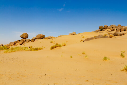 Sahara landscape. Rock formations with large, round boulders on a dune. Tassili n'Ajjer National Park, Algeria, Africa