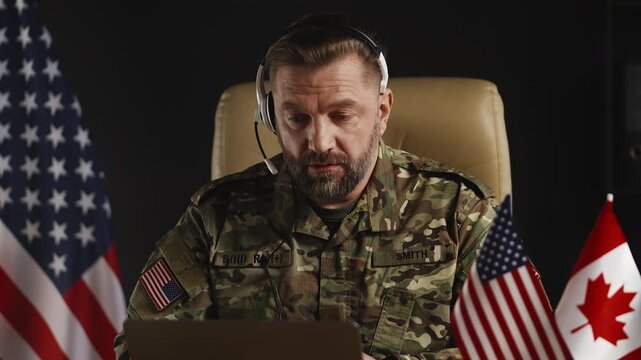 American military attache in headset discussing defense strategy via video call