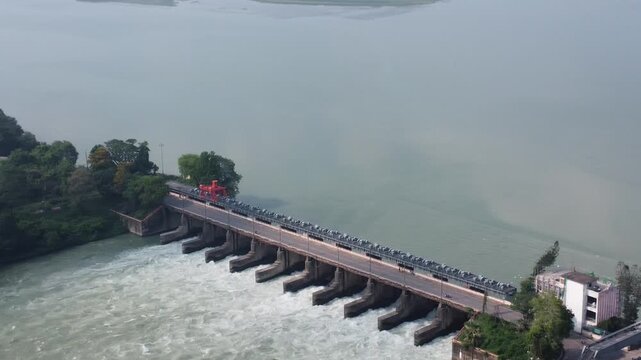 drone video clip of river barrage with moving vehicles on  bright sunny day in India