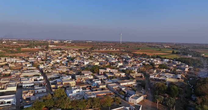 Aerial view of well-organised agricultural land near Rajkot city in Gujarat, India. The image showcases neatly divided farmland patterns, vibrant green fields, and rural landscapes.