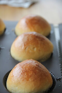 Freshly baked brioche buns with soft buttery texture