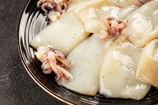 Raw squid fresh seafood marinated tasty snack fresh, delicious, gourmet food background on the table  rustic food top view copy space pescetarian diet