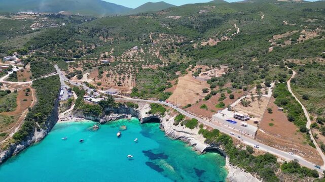 Spectacular drone view of Xigia Sulfur Beach in Zakynthos. Famous for its healing sulfur springs, crystal turquoise water, and steep limestone cliffs in a scenic Greek island bay.