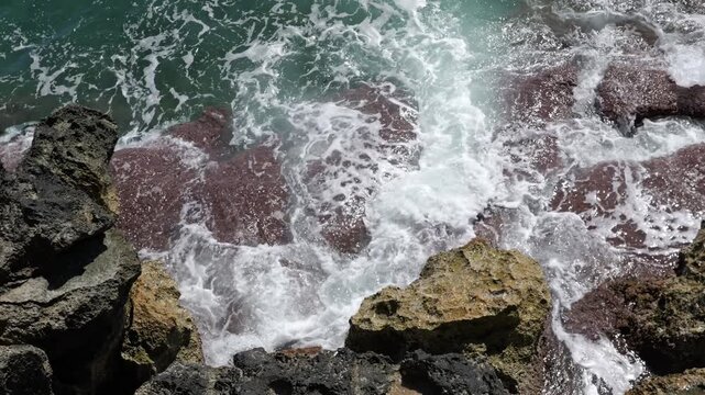 Gentle waves flow from a top-down perspective over a rugged rocky coastline in Cala Blava, Mallorca,  4K UHD (3840x2160), 25fps, 60 seconds, 871 MB.