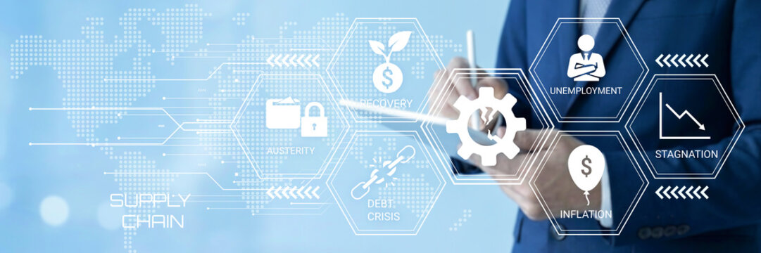 Business professional analyzing economic factors and supply chain management with digital interface visuals