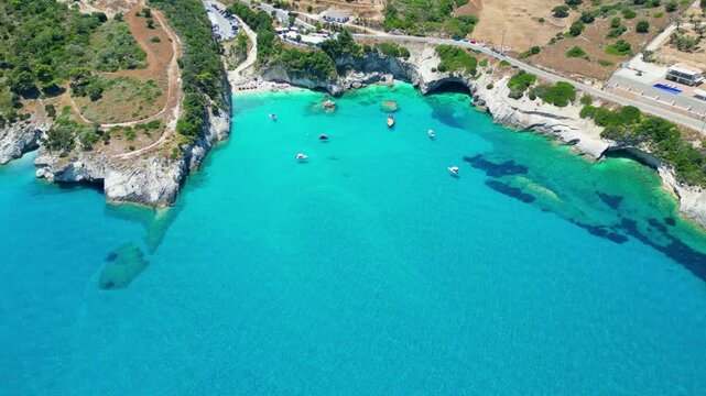Spectacular drone view of Xigia Sulfur Beach in Zakynthos. Famous for its healing sulfur springs, crystal turquoise water, and steep limestone cliffs in a scenic Greek island bay.