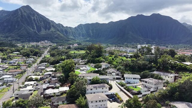 Residential homes in the town of Kaneohe with the Koolau mountains in the background on Oahu in Hawaii. 
