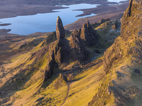 Aerial view of The Storr rocky pinnacles and the Old Man of Storr overlooking Loch Leathan during golden hour Isle of Skye, Scotland, United Kingdom.