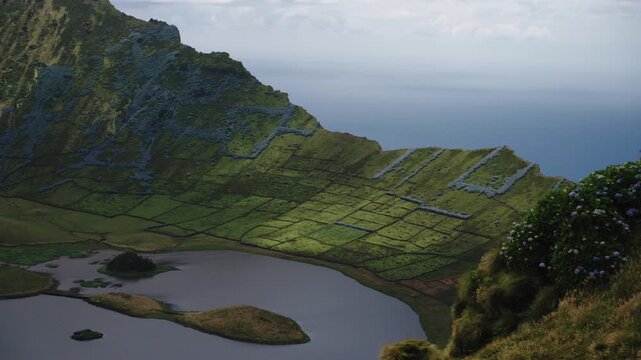 Cinematic High-Angle View of the Caldeir o Crater Rim with Hydrangeas and Volcanic Lake, Corvo Island, Azores