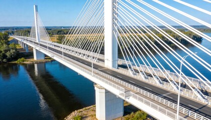 Naklejka premium Spanning cable-stayed bridge crossing river on sunny day, featuring central pylon and stay cables