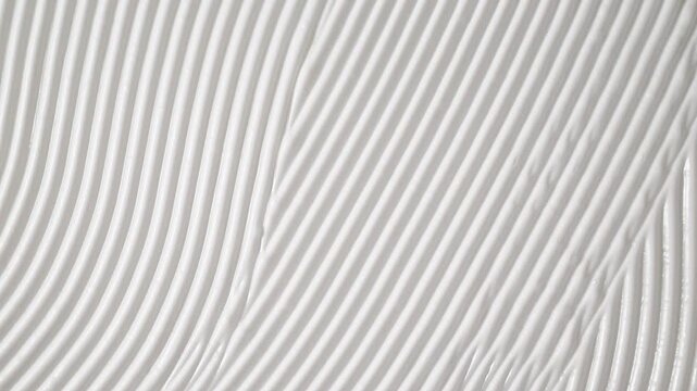 Smooth white cosmetic cream texture scrolling up top view. White face body cream texture moving smoothly. Perfect for skincare and beauty industry advertising.