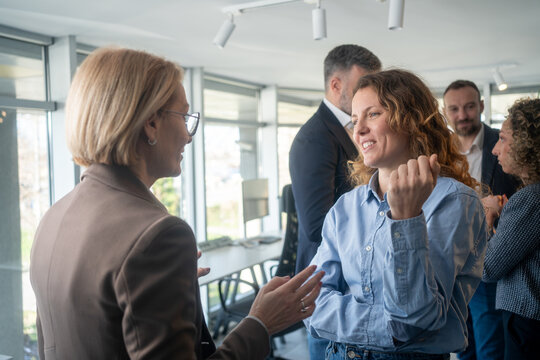 Business women having a constructive conversation during a break in a meeting