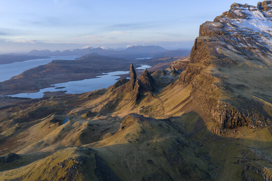 Aerial view of The Storr rock formation with rugged cliffs and Loch Leathan under a soft sky Isle of Skye, Scotland, United Kingdom.