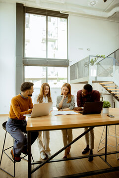 Team collaborates in modern workspace during business meeting in the morning