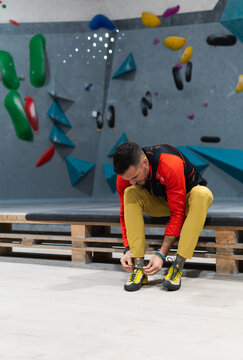 Focused climber preparing for bouldering training session indoors
