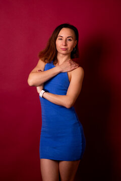 Confident Woman in Blue Dress Posing in Studio