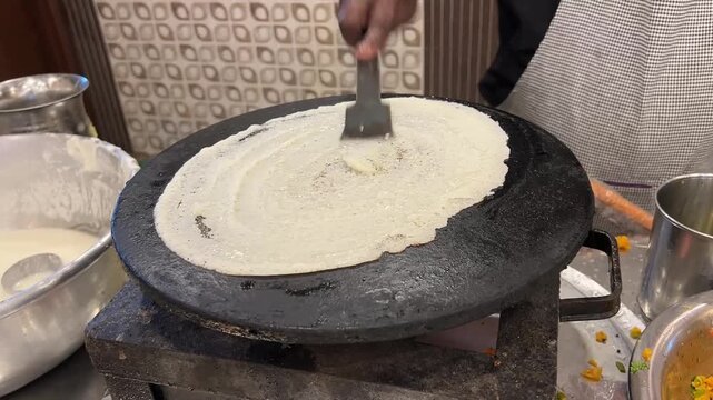 Masala dosa prepared in Kolkata style in a restaurant; professional food photography of traditional crispy rice crepe, spiced potato filling, sambar, and popular South Indian breakfast cuisine in West