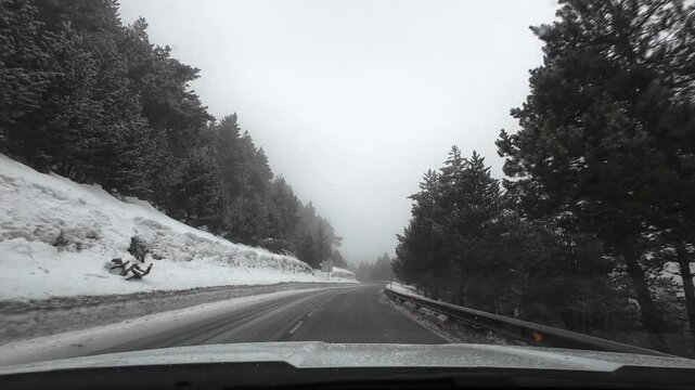 Driving on a foggy mountain road during winter in the Pyrenees