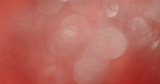 Elegant and beautiful abstract red and pink shimmering background with sparkling and glittering bokeh lights, creating a soft, romantic, and celebratory atmosphere for holidays or special events
