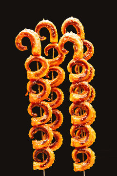 Close up of skewed grilled calmars  at street food snack bar in China