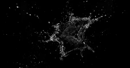 Dynamic water splash explosion isolated on black background with realistic liquid droplets for VFX overlay and cinematic visual effects © Jag_cz