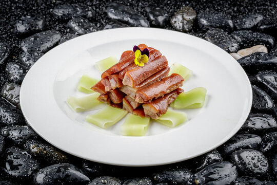 The gluttonous pig tails were placed on black pebbles.