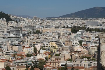 Fototapeta premium Panoramic view of the urban fabric of Athens, Greece, with the Greek Parliament visible in the middle and the Mount Hymettus in the background
