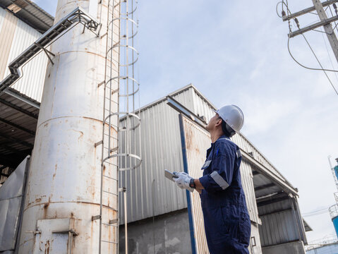 Engineering work using digital tablet maintenance Exhaust system concept Clean air environmental protection. Factory industrial manufacturing. Sustainable future environment air pollution reduction