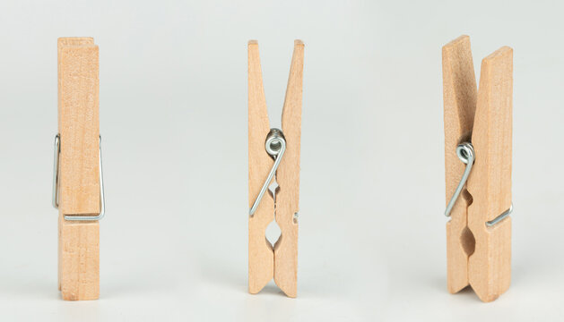 Clothespins in different positions isolated on a light background