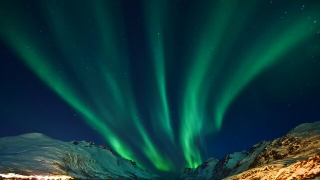 Spectacular radial Aurora Borealis forming a corona in the deep blue starry sky above snowy peaks. Bright green rays spreading across the atmosphere. Dramatic arctic night scene.