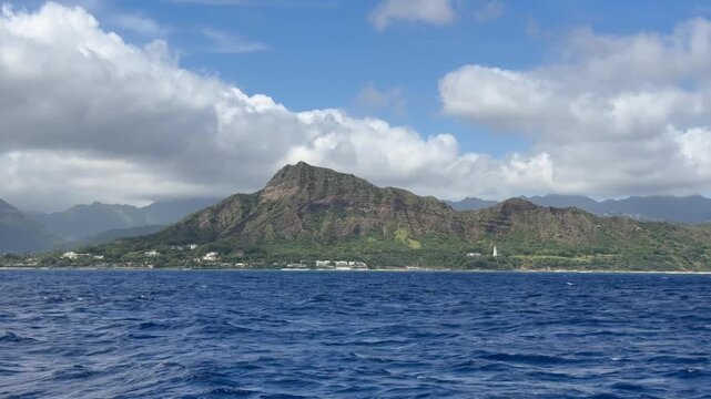View of Diamond Head crater from a sailboat off Waikiki Beach in Honolulu on the island of Oahu in Hawaii. 