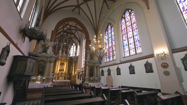 Vilnius, Lithuania &ndash; May 11, 2026: Smooth sliding shot inside Gothic St. Anne&rsquo;s Church in Vilnius, Lithuania