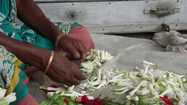 skilled artisan crafting fragrant tuberose and rose garlands