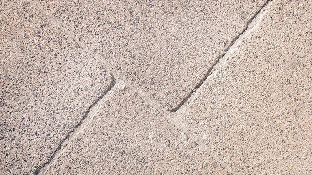 Light concrete pavement texture with geometric sidewalk pattern background