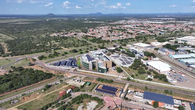 Aerial View of Curved Office Building with Extensive Solar Power Infrastructure