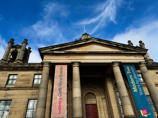 Obraz premium Neoclassical Modern Two Dean Gallery entrance with towering columns and colorful banners at a historic art gallery and museum in Edinburgh, Scotland, UK