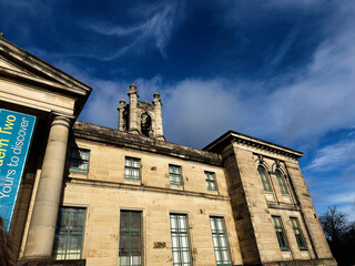 Obraz premium Historic neoclassical Modern Two Dean Gallery building with bell tower in Edinburgh Scotland UK under dramatic blue sky