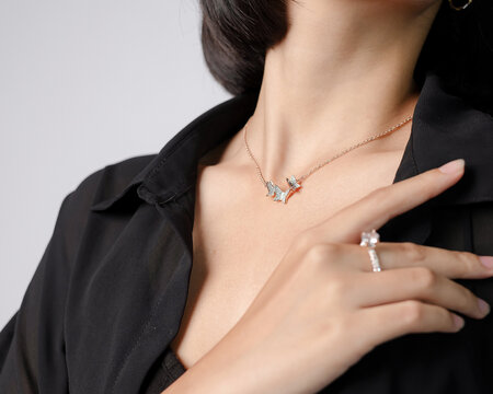 Luxury beauty portrait featuring elegant butterfly pendant necklace combined with sparkling diamond ring on stylish female model. Premium jewelry concept suitable for fashion branding