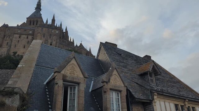 Mont Saint Michel rises majestically against the serene sky. Experience the enchanting beauty and historical architecture of this unique destination.