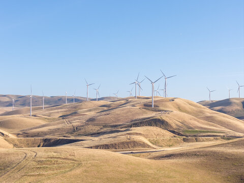 Wind turbines on Altamont Pass hills creating clean, renewable power for a greener future, symbolizing environmental responsibility and modern energy solutions in California